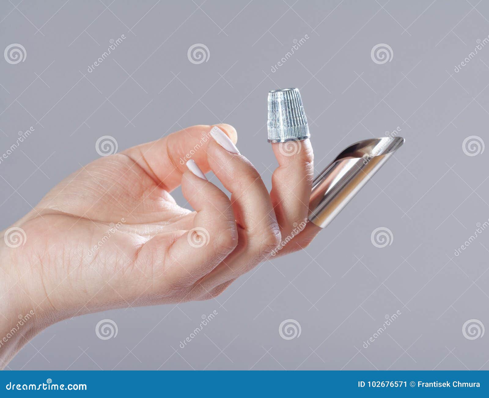 Hand with Two Thimbles on Fingers. Stock Image Image of tool, metal