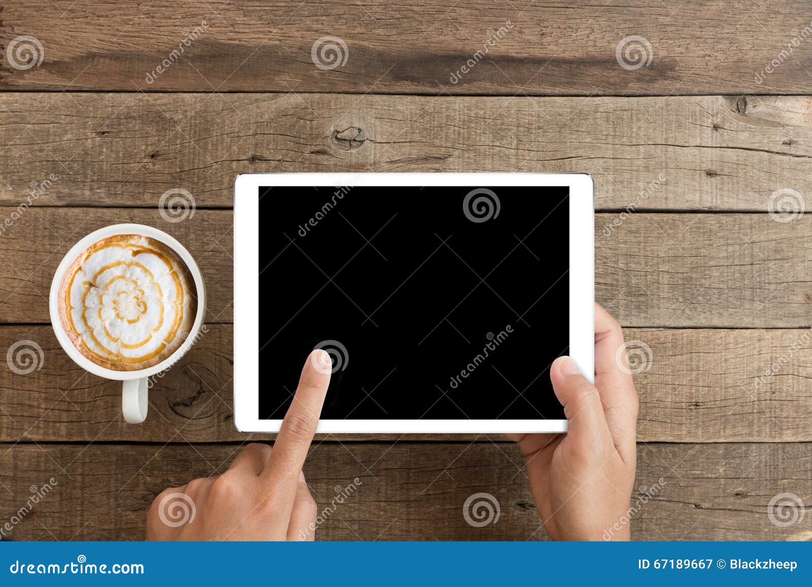 hand using mockup tablet on wood desk with clipping path displa