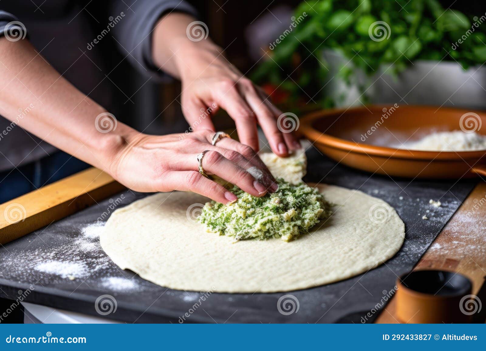 Hand Using a Rolling Pin To Flatten Out Cauliflower Pizza Dough Stock