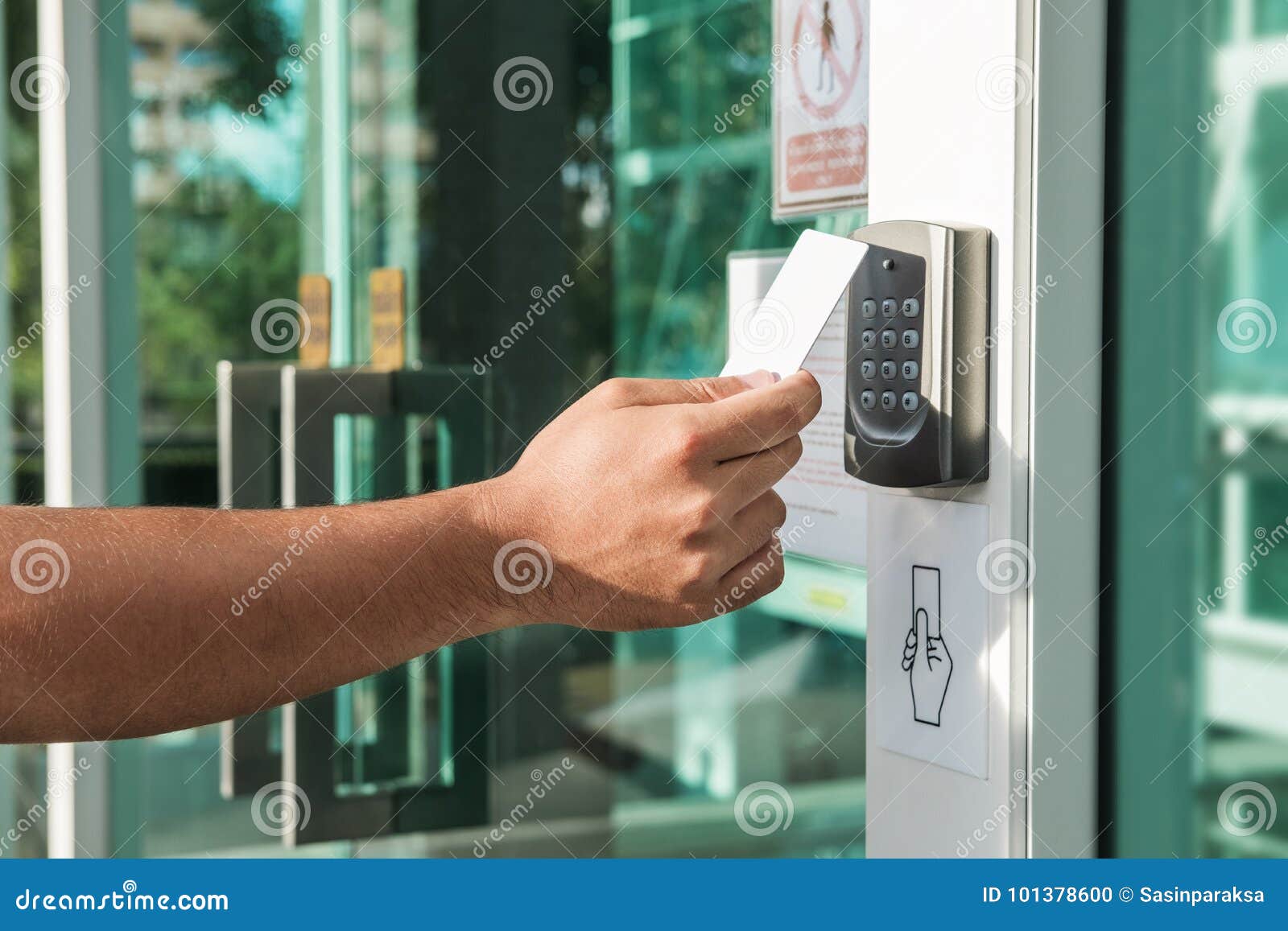 hand using security key card scanning to open the door to entering private building. home and building security system