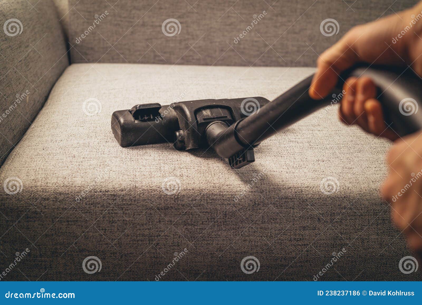 Hand Using Vacuum Cleaner on the Grey Sofa Stock Photo Image of young
