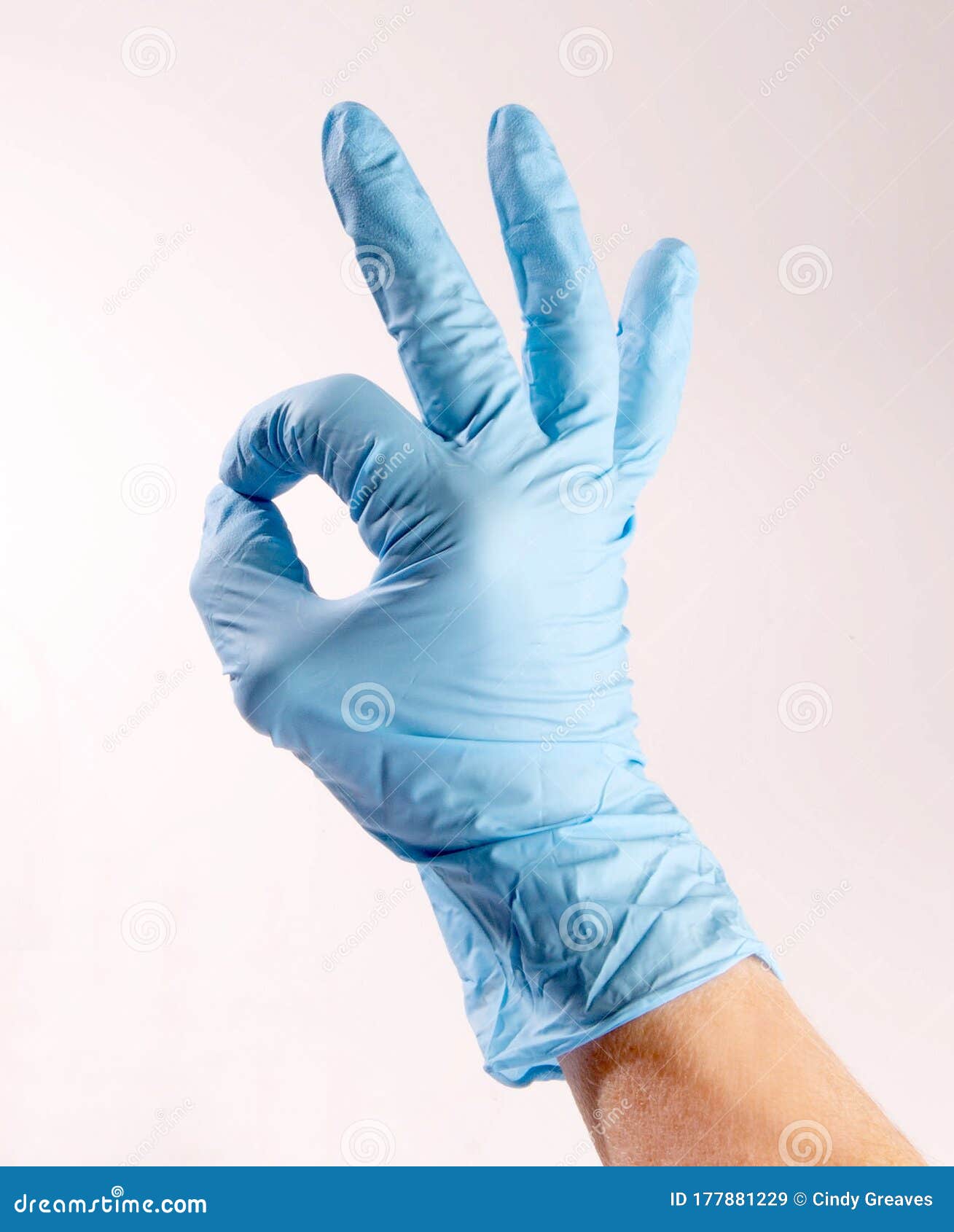 hand wearing ppe signing ok
