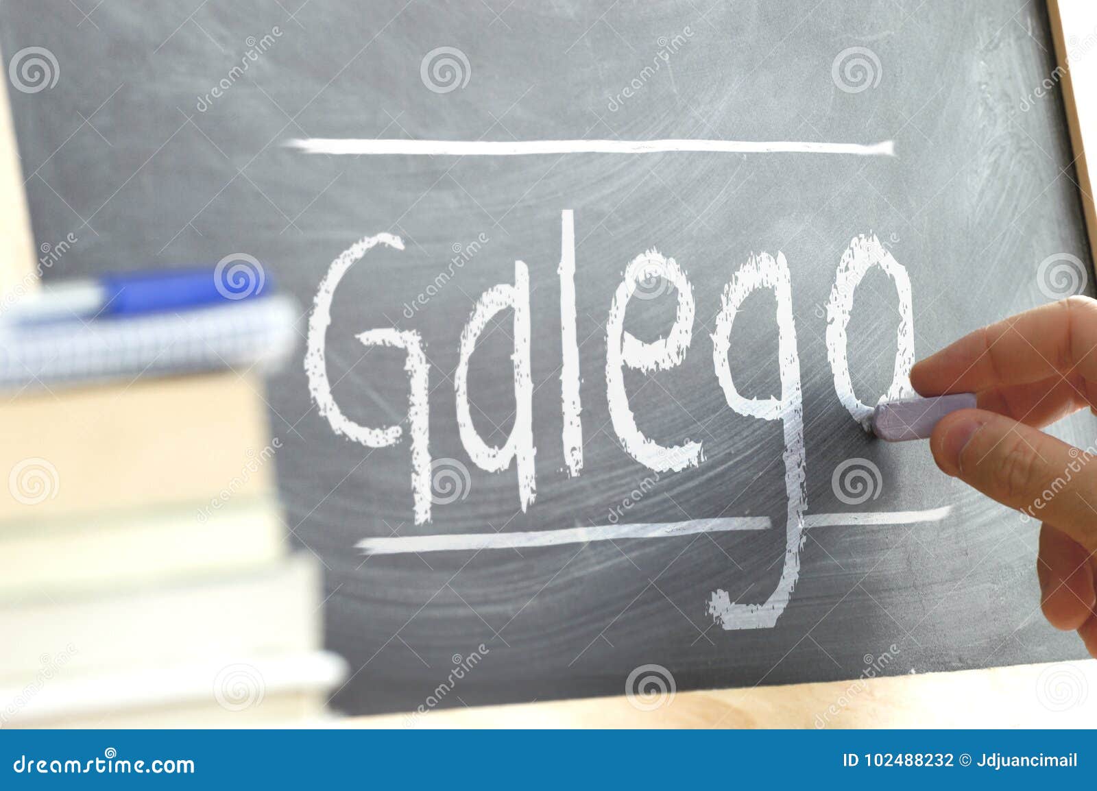 hand writing on a blackboard in a language class with the word galician wrote on.