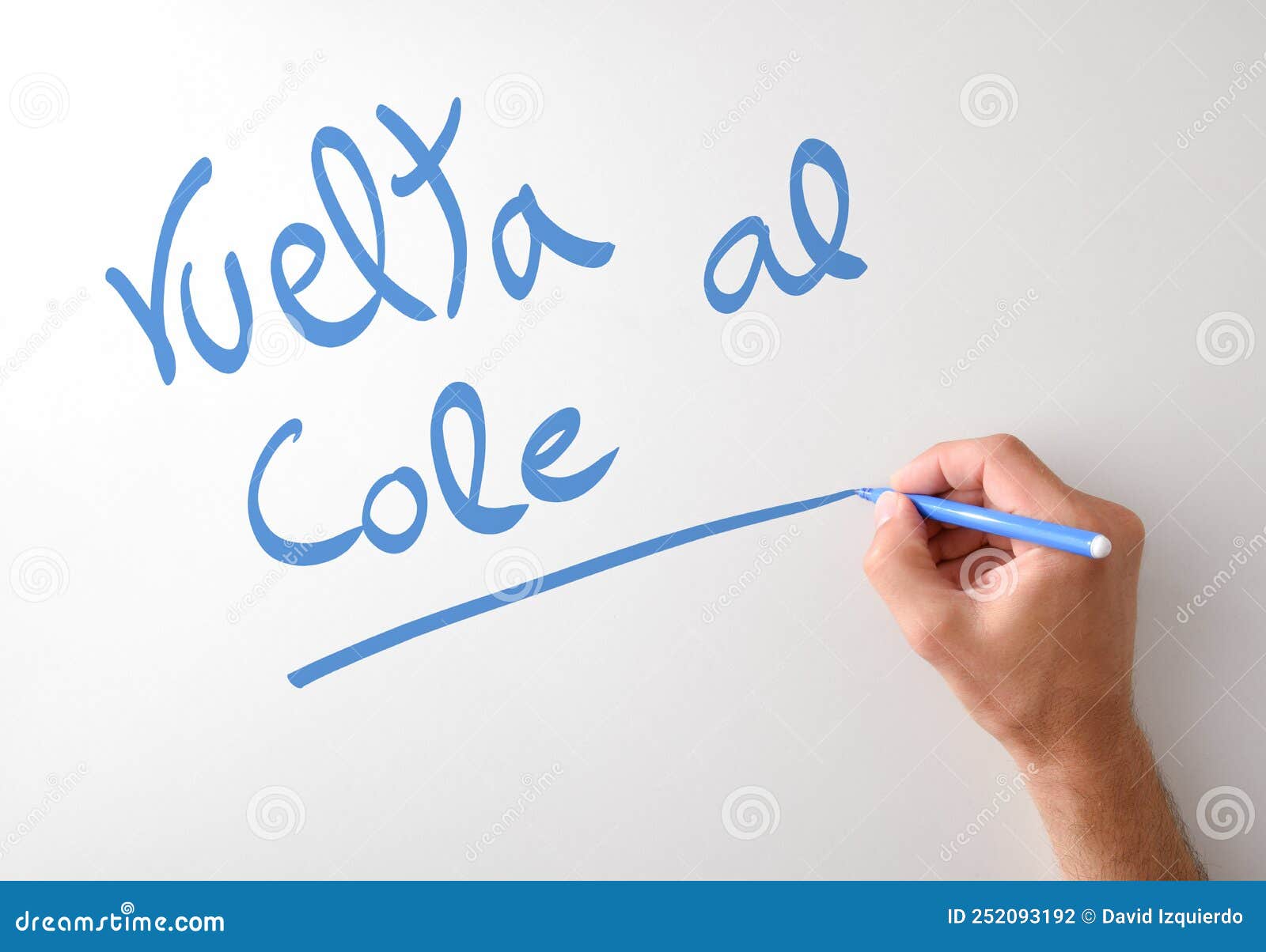 hand writing vuelta al cole on white board