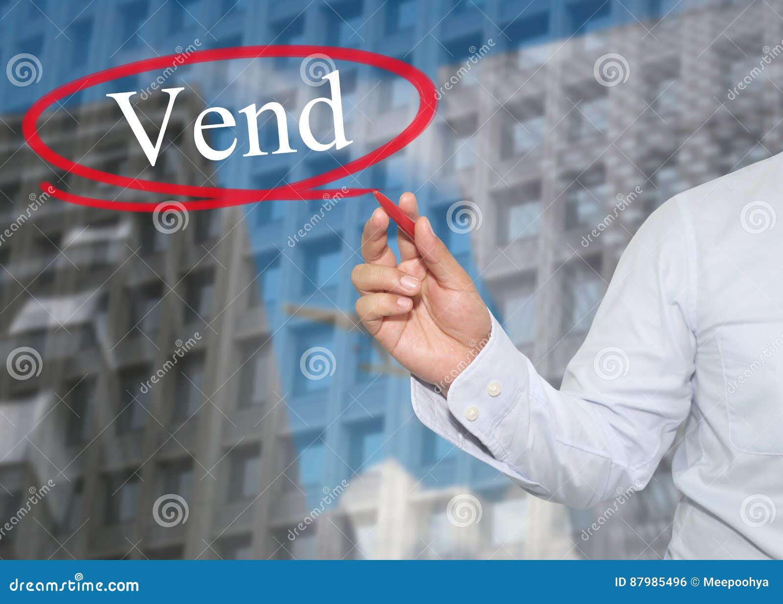 hand of young businessman write the word vend on skyscrapers background.