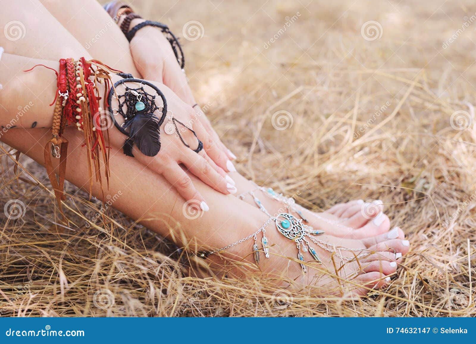 handcrafted bracelets on a woman legs and hands, dreamcatcher jewelry
