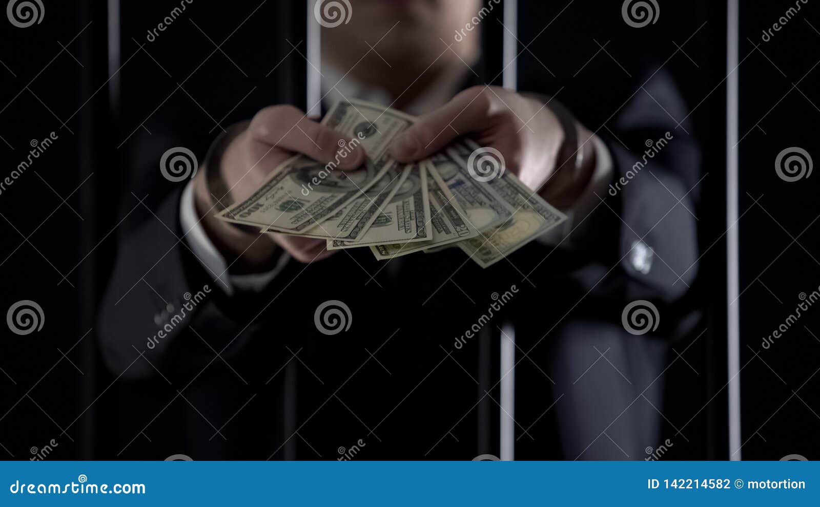 handcuffed businessman holding dollar banknotes, tax evasion, money laundering