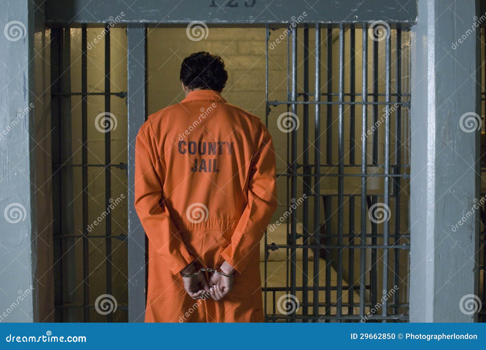 handcuffed prisoner in jail