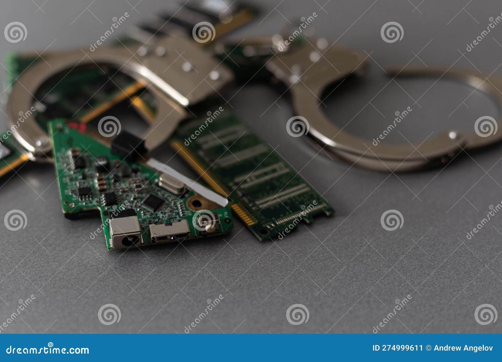 Handcuffs Against a Computer Electronics Board. the Concept of
