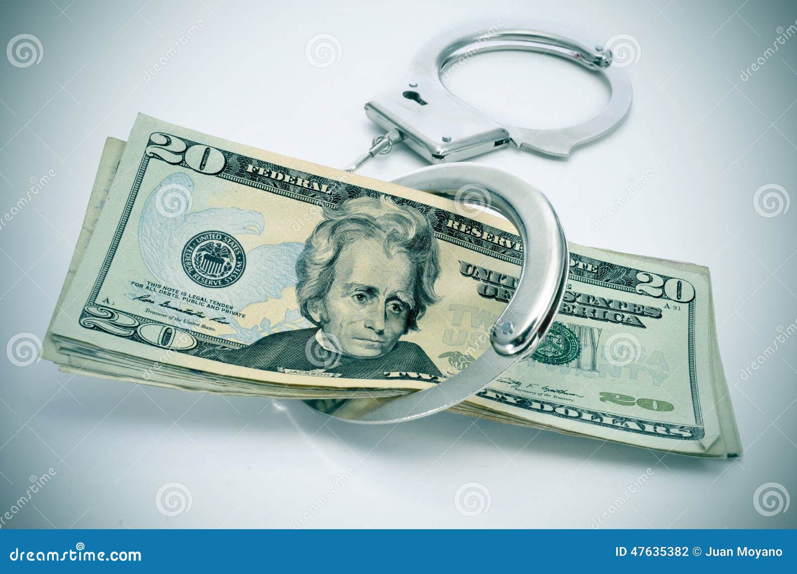 Handcuffs and dollar bills stock photo. Image of handcuffs 47635382