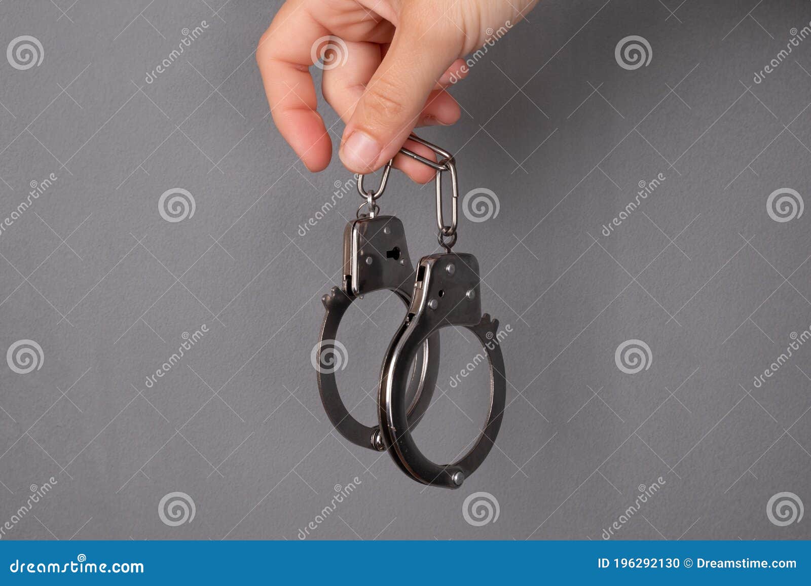 handcuffs on gray background, punishment for a crimen