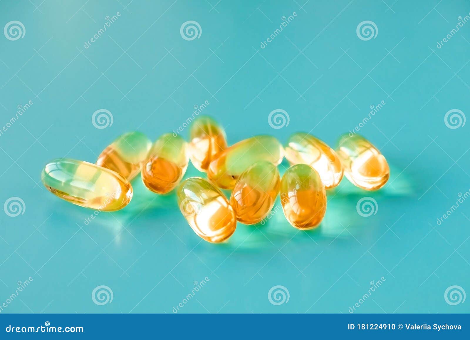 Handful of Omega 3 Capsules on a Blue Background . Stock Photo Image