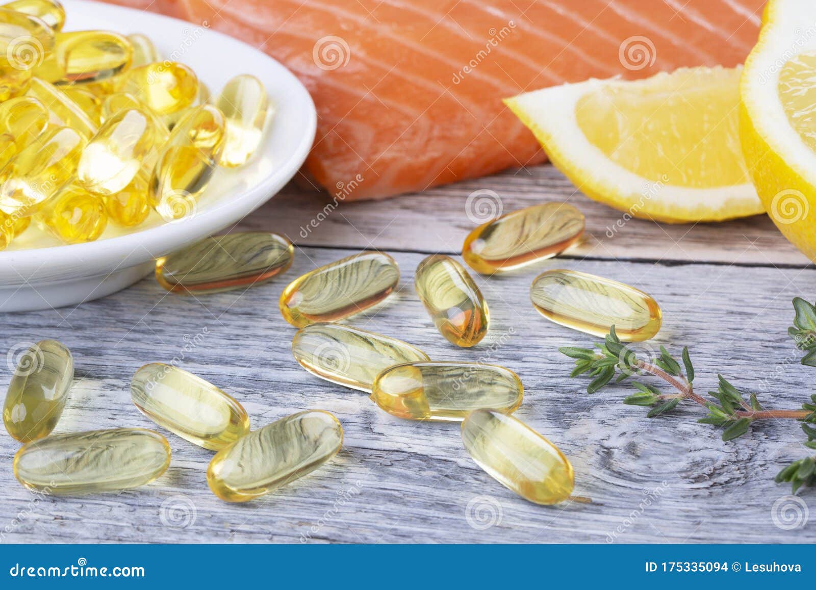 handful of omega 3 softgels and salmon filet