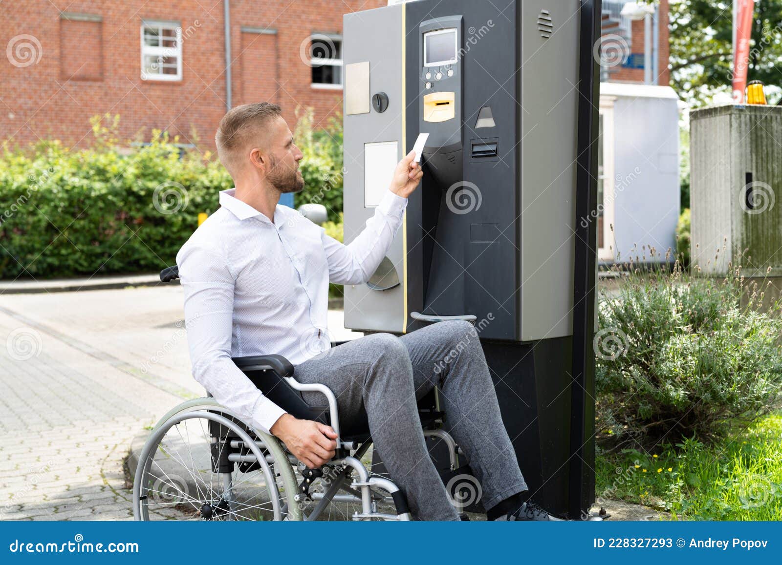Handicapped Man in Wheelchair Paying for Car Parking Ticket Stock Image