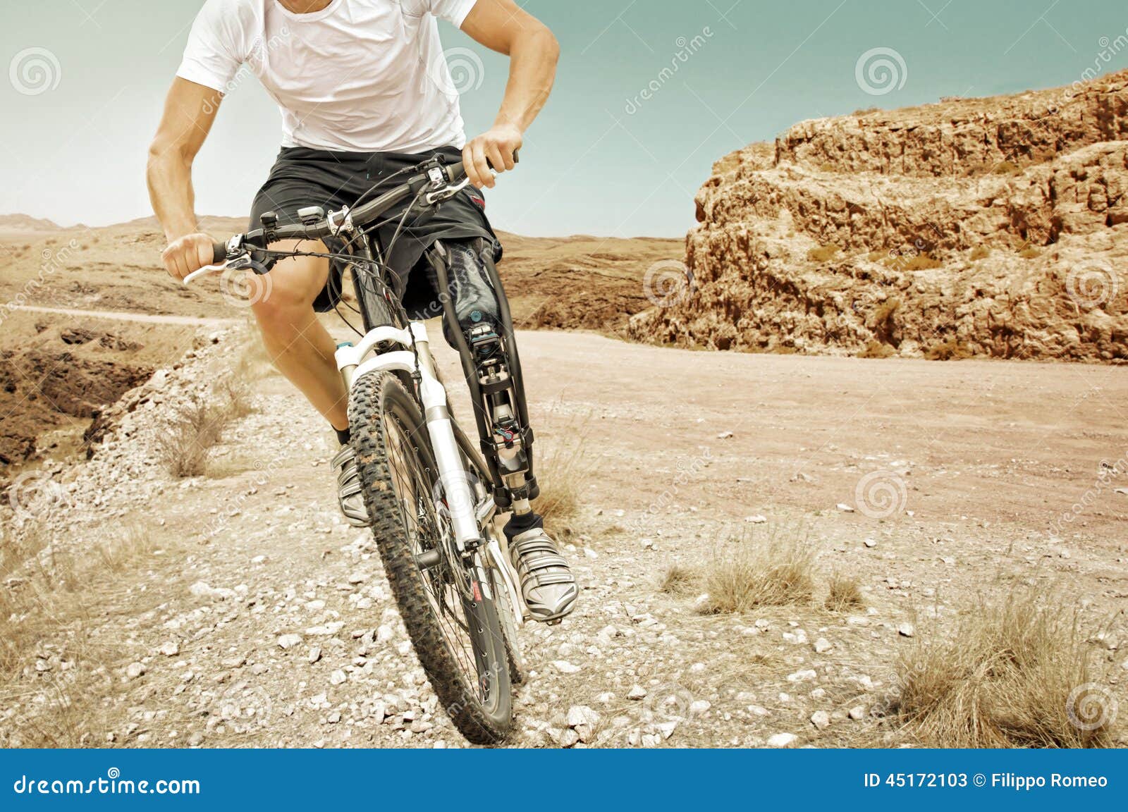 handicapped mountain bike rider barren landscape
