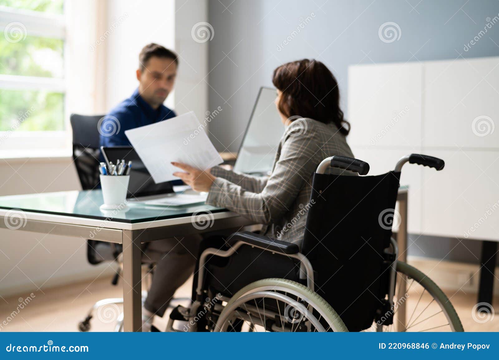 Handicapped Worker in Wheel Chair Stock Photo Image of table, desk 220968846