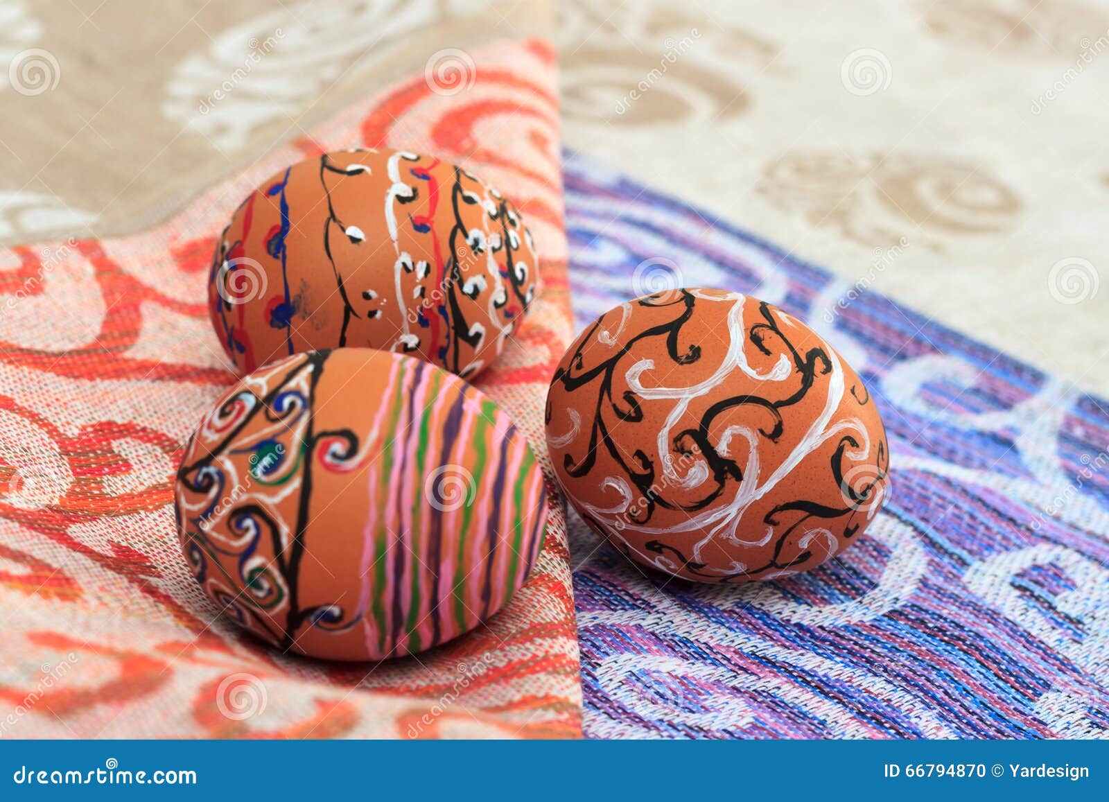 Handmade colorful painted easter egg against matching tablecloth. Handmade colorful painted easter eggs composition against matching tablecloth, close u view. Easter greeting card concept