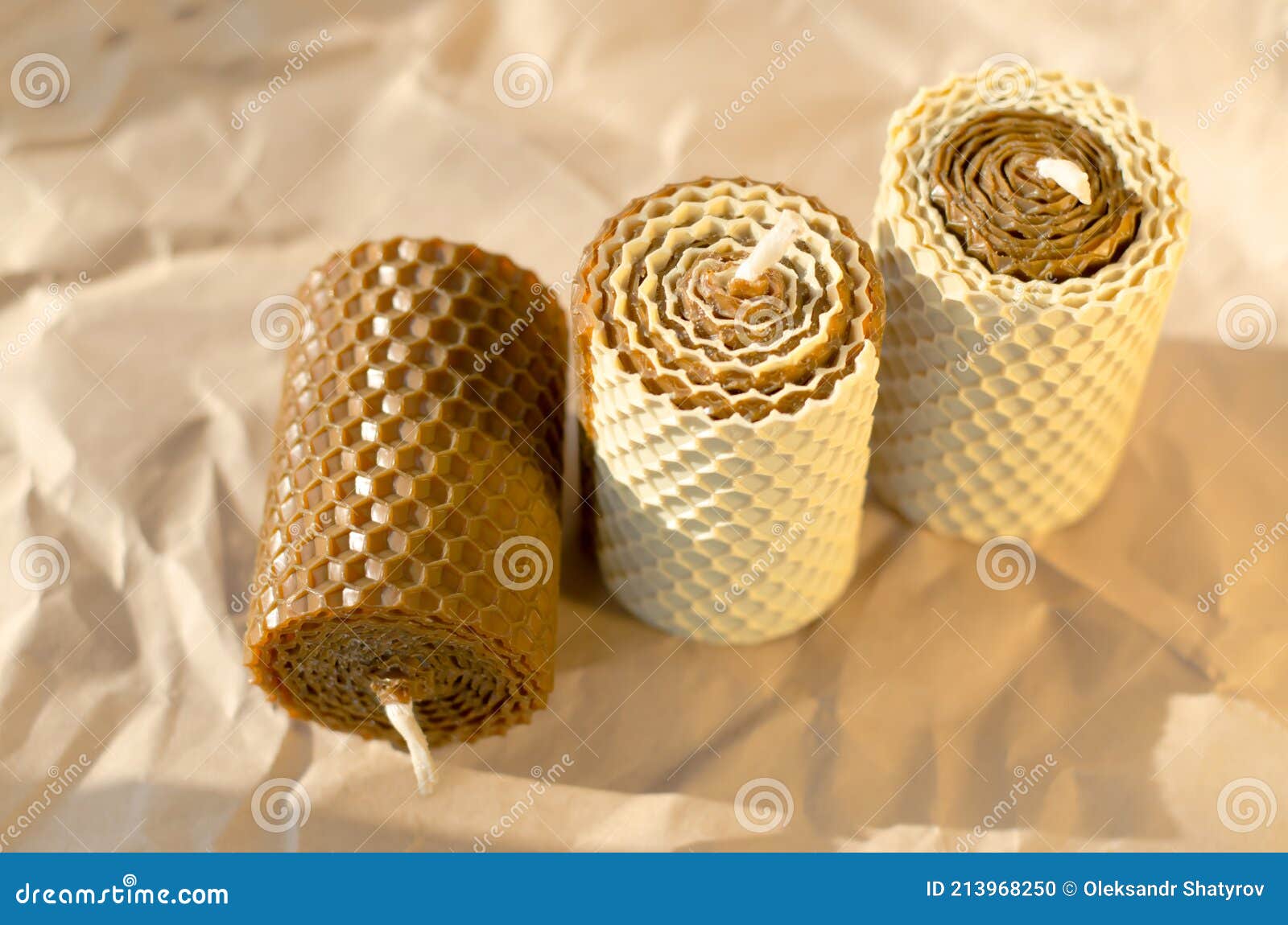 Handmade Decorative Wax Candles on Crumpled Parchment Paper Stock Photo