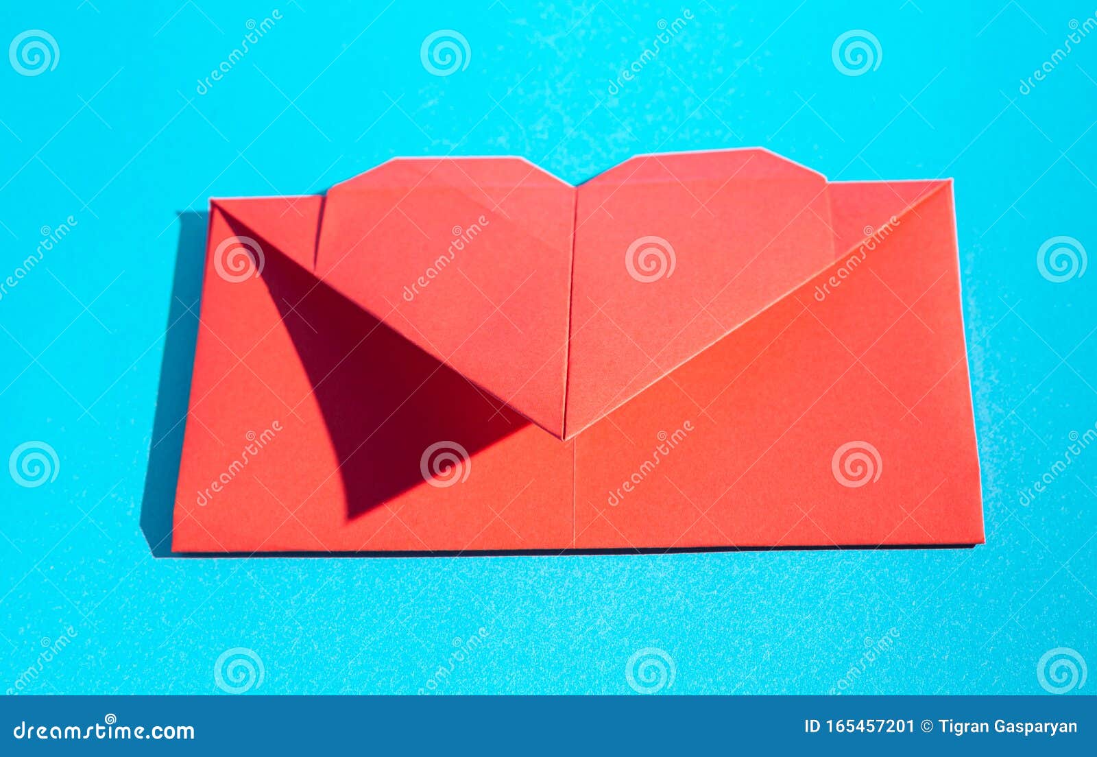 Red origami paper hearts on wood board background Vector Image