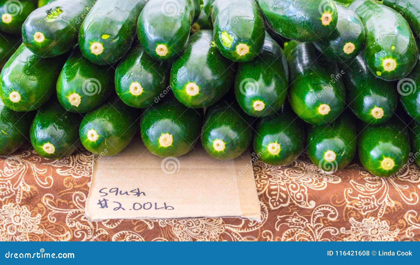 handmade misspelled cardboard sign with squash for sale