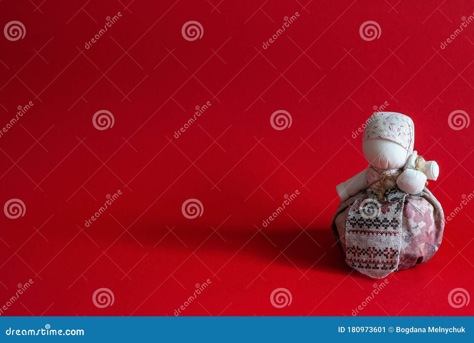 handmade textile dolls on red background