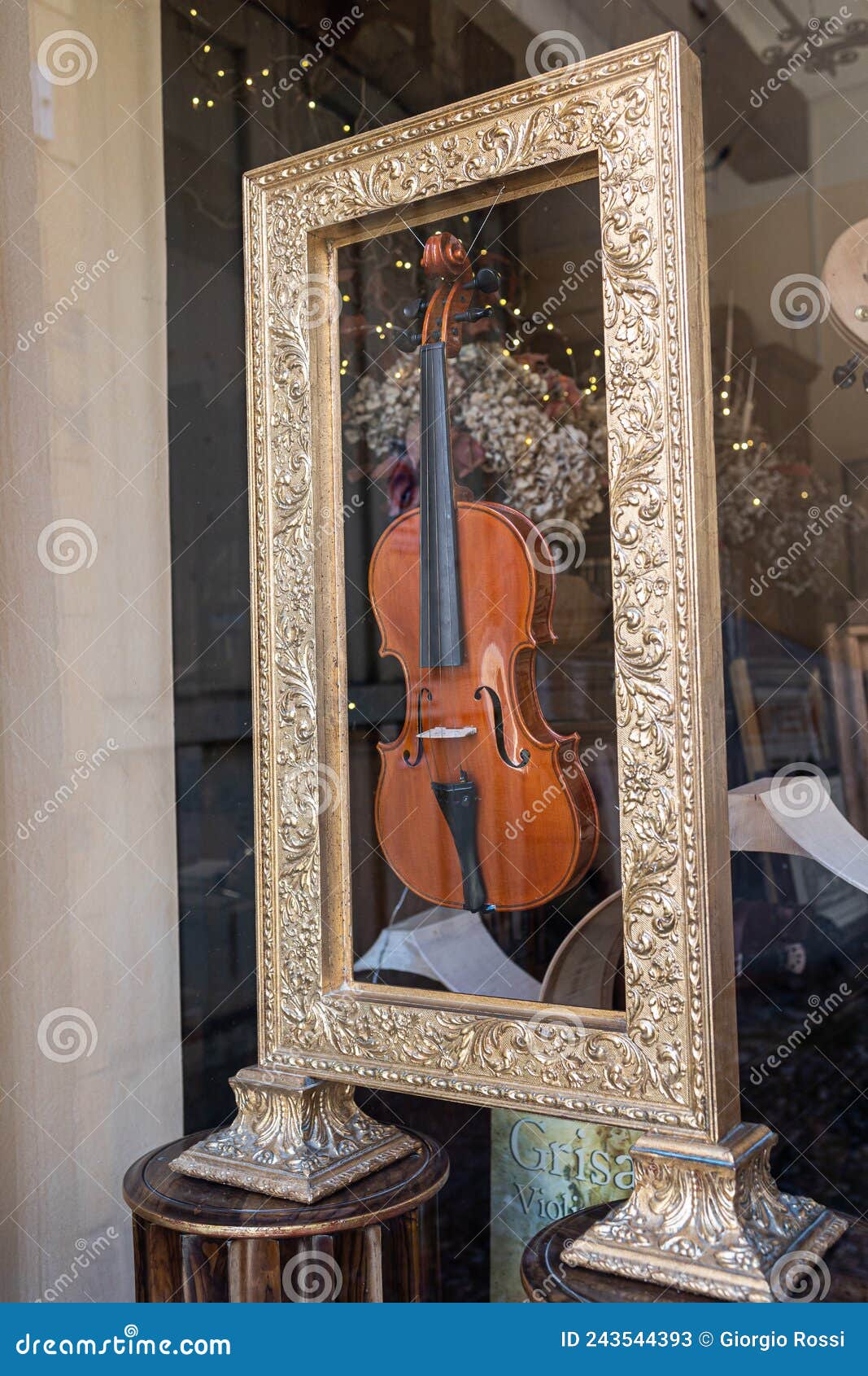 Handmade Violin Inserted Inside a Golden Frame Editorial Stock Photo