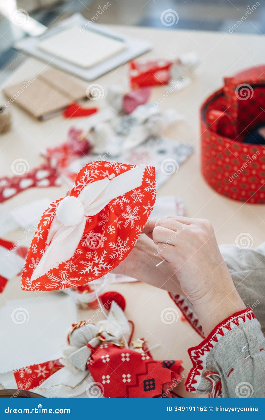 handmaking holiday decor with red and white fabric. showcasing festive cultural crafts and slavic-inspired sewing