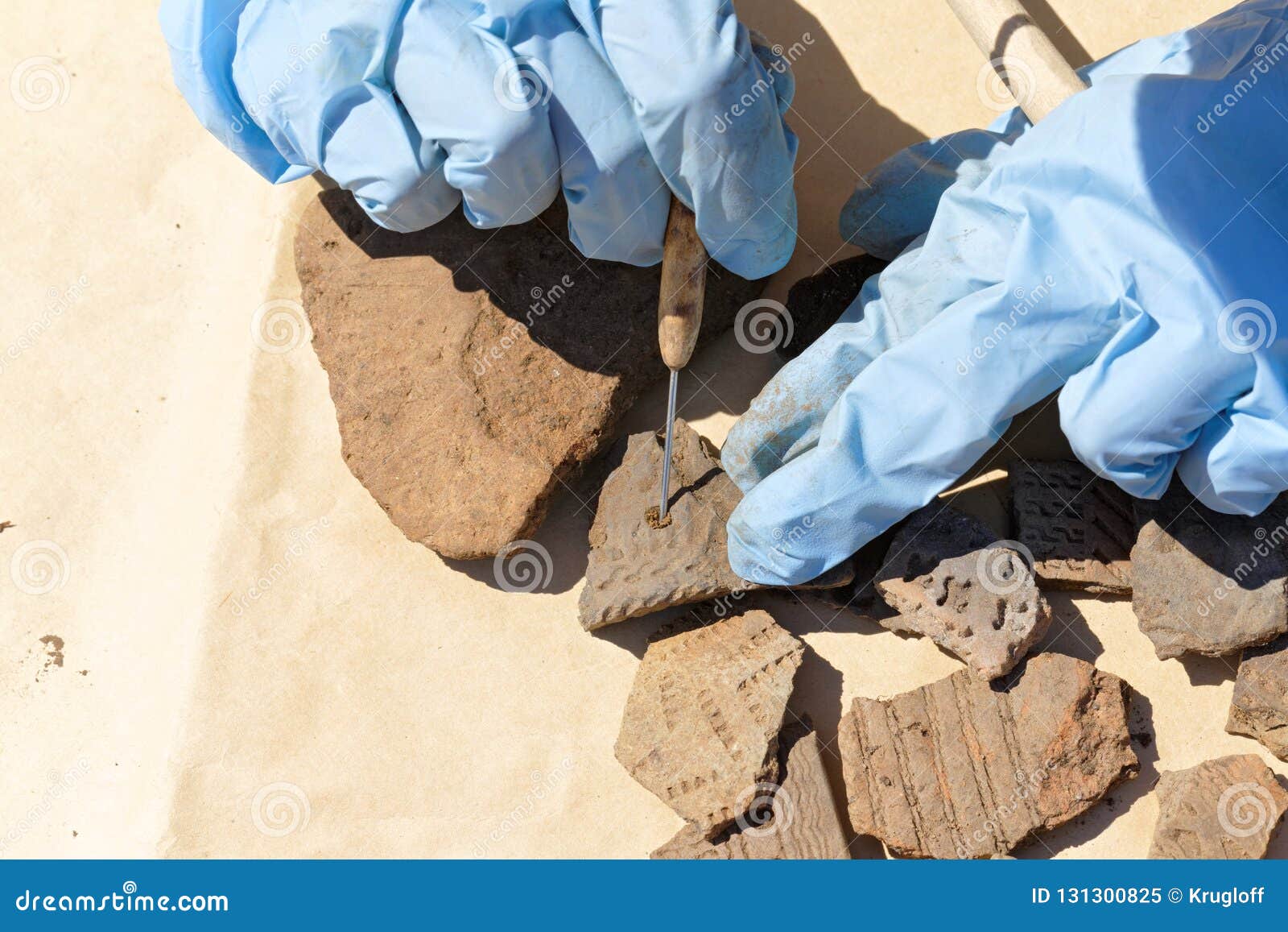 Hands Archaeologist Cleaned with a Scraper of Clay from a Fragment of ...