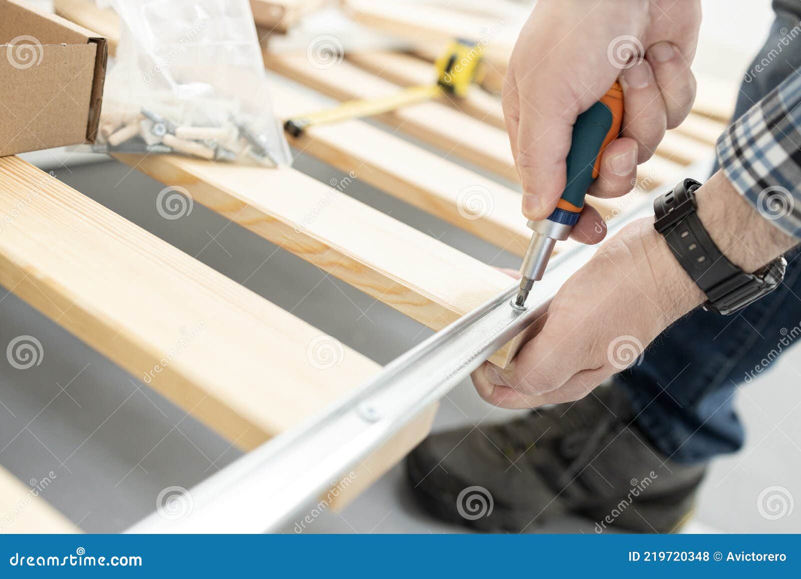 Hands Assembling a Bed Frame Using a Screwdriver Stock Photo Image of