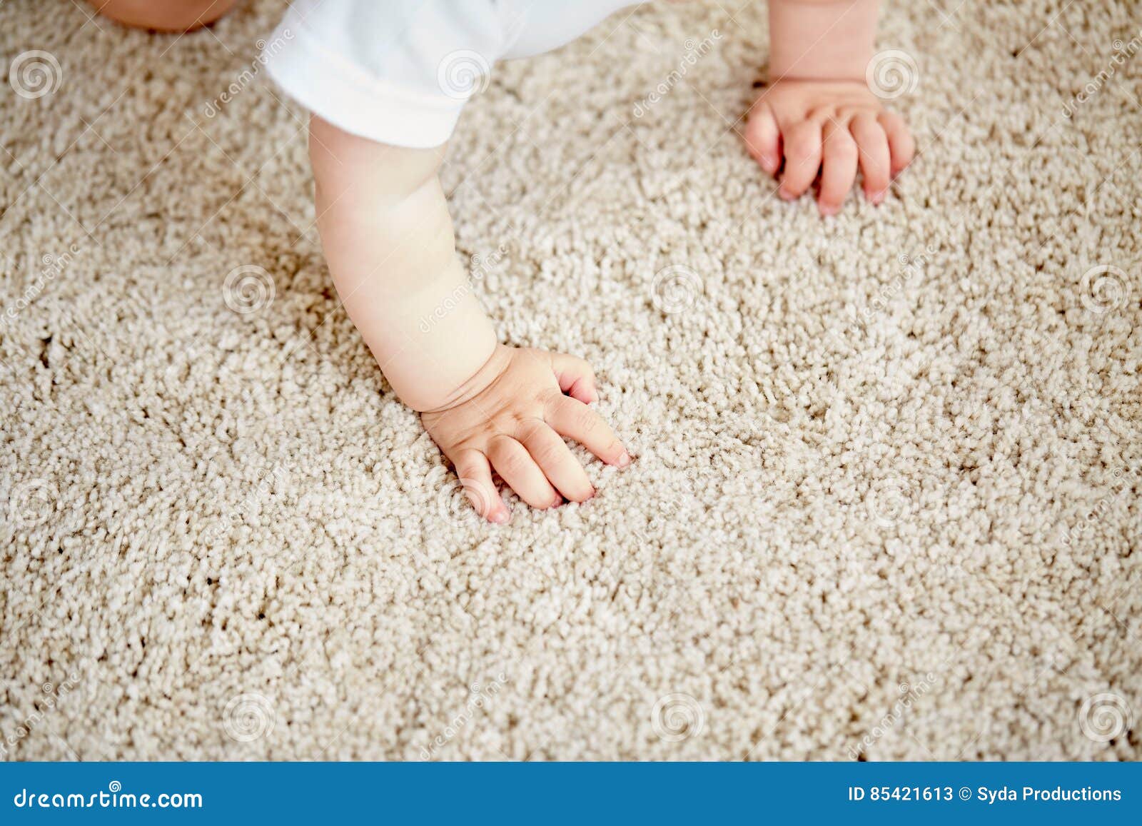 hands of baby crawling on floor or carpet