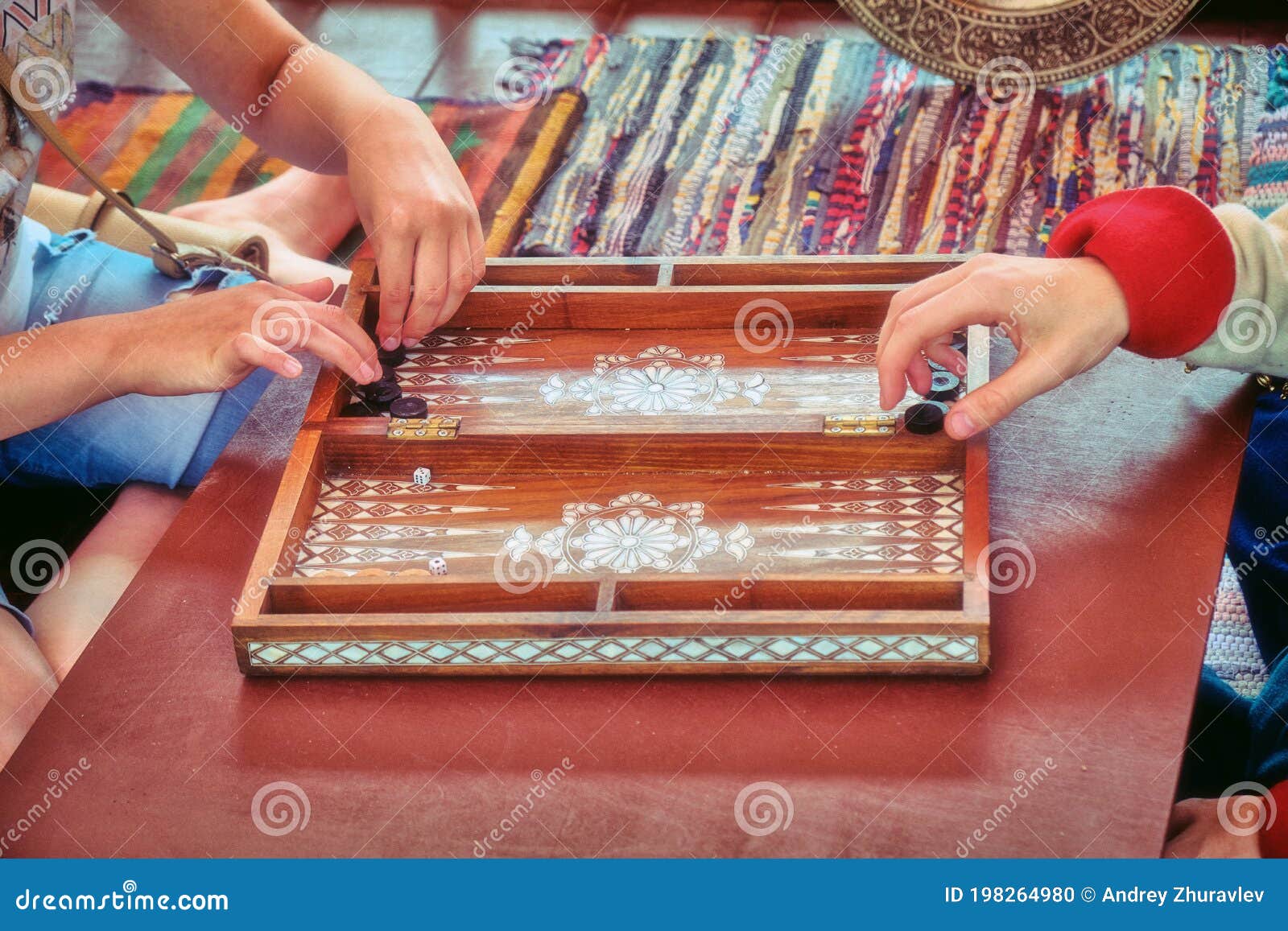 Hands of Backgammon Players. Two People are Playing at the Retro Board