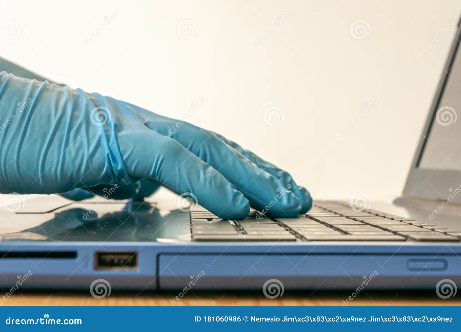 Hands with Blue Nitrile Gloves Using a Labtop Keyboard Stock Photo