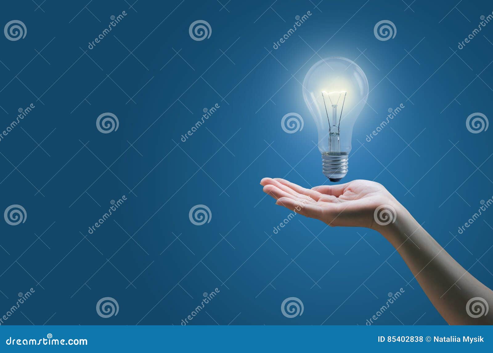 Hands of Business Person Under the Burning Lamp. Stock Photo Image of