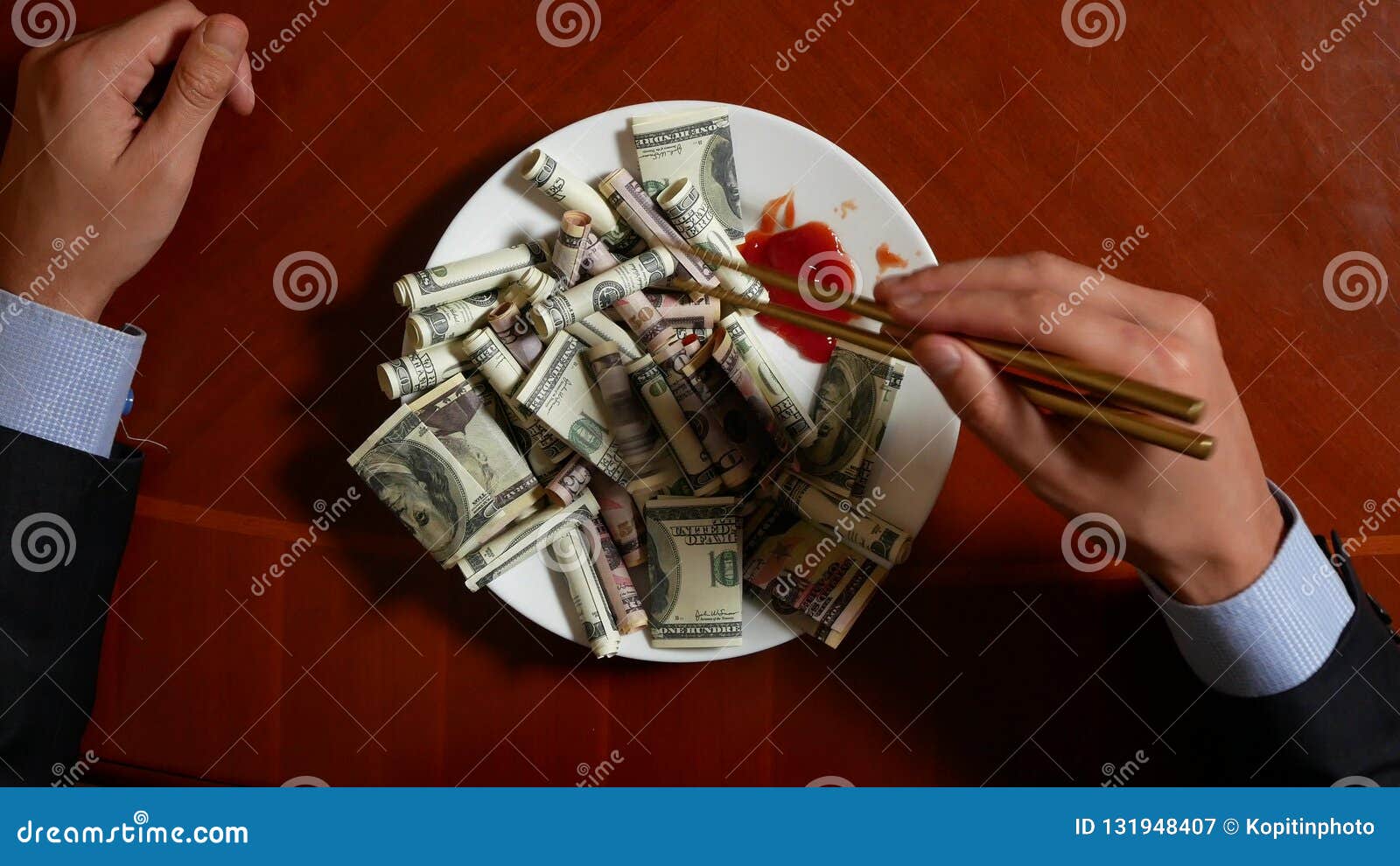Hands of a Businessman with Chopsticks and Dollar Rolls. Eating Dollars