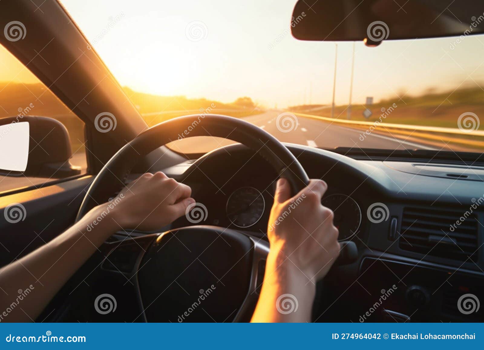 Hands of a Car Driver on the Steering Wheel during a Road Trip