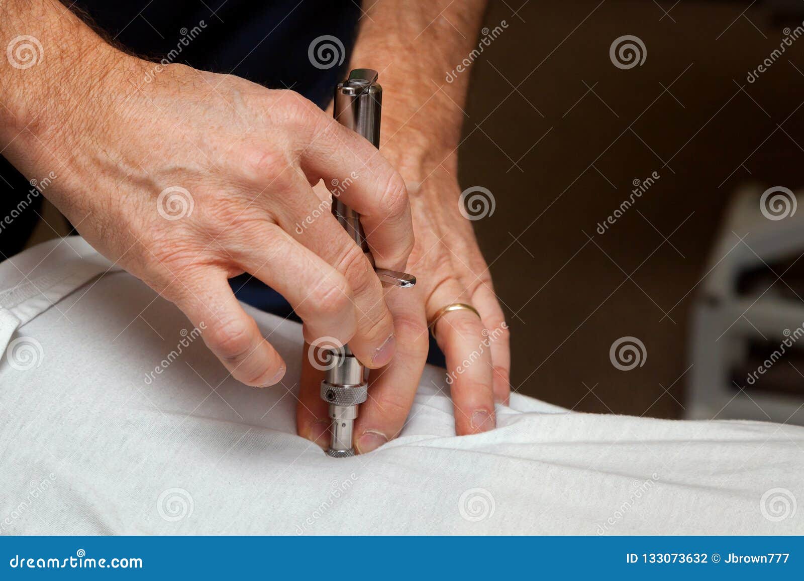 hands of a chiropractor using an integrator to adjust the spine