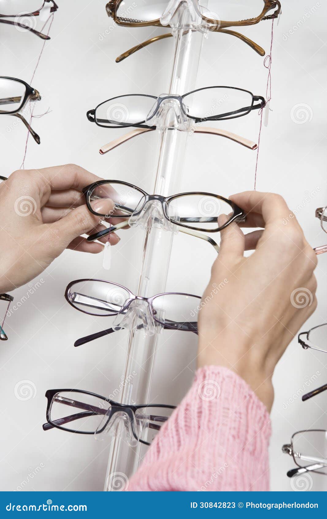 Hands Choosing Eyeglasses from Rack Stock Image Image of hispanic