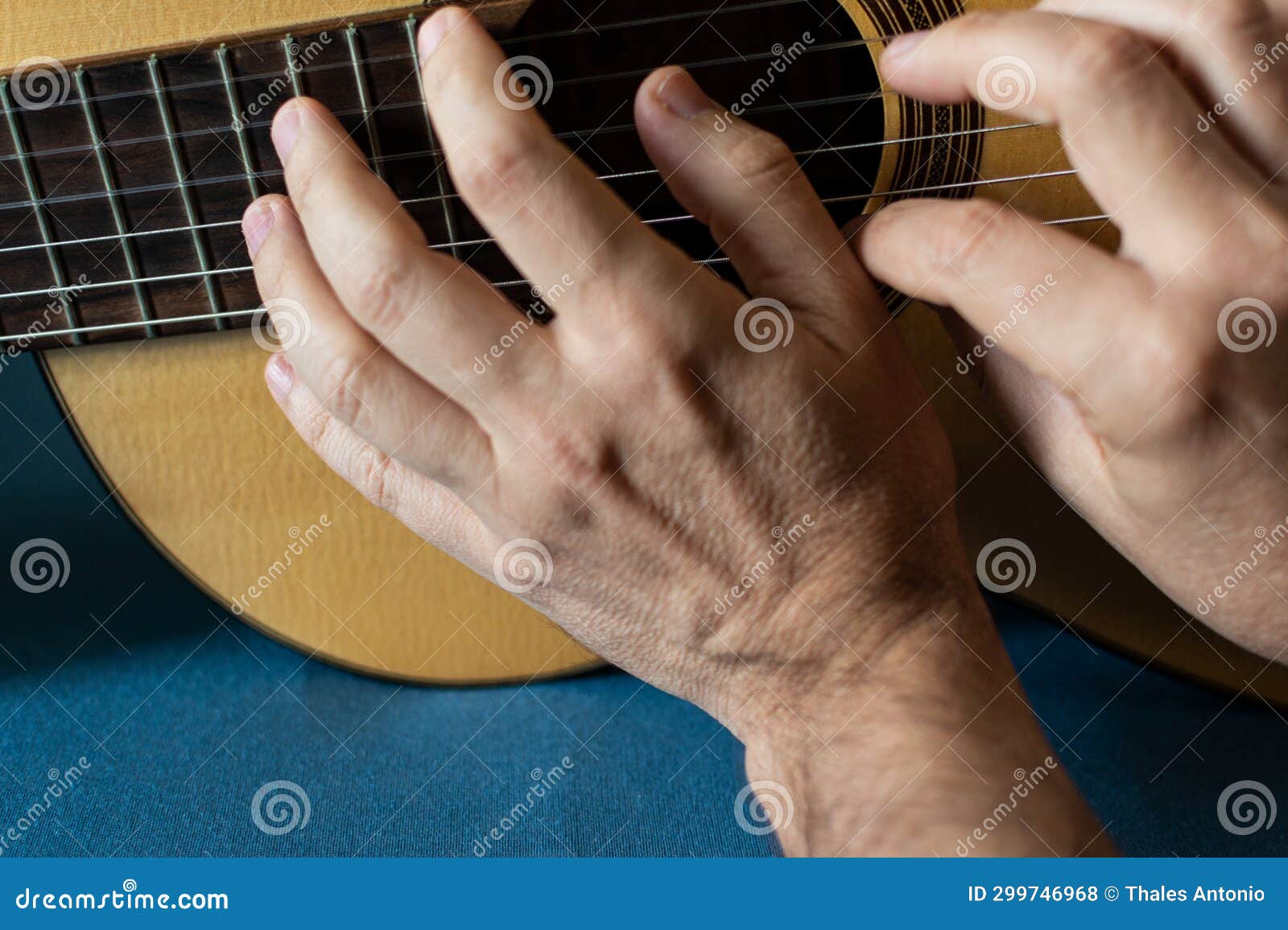 Hands of a Classical Guitarist on Top of the Guitar. Study of Classical
