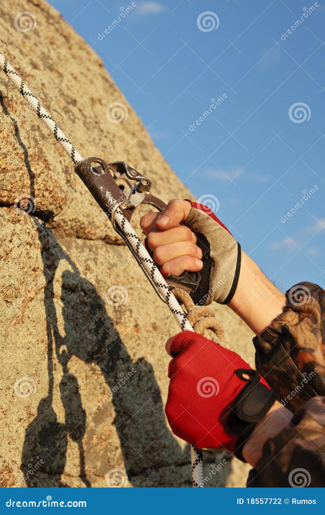 Hands of Climber Working with Equipment on Rock. Stock Photo Image of