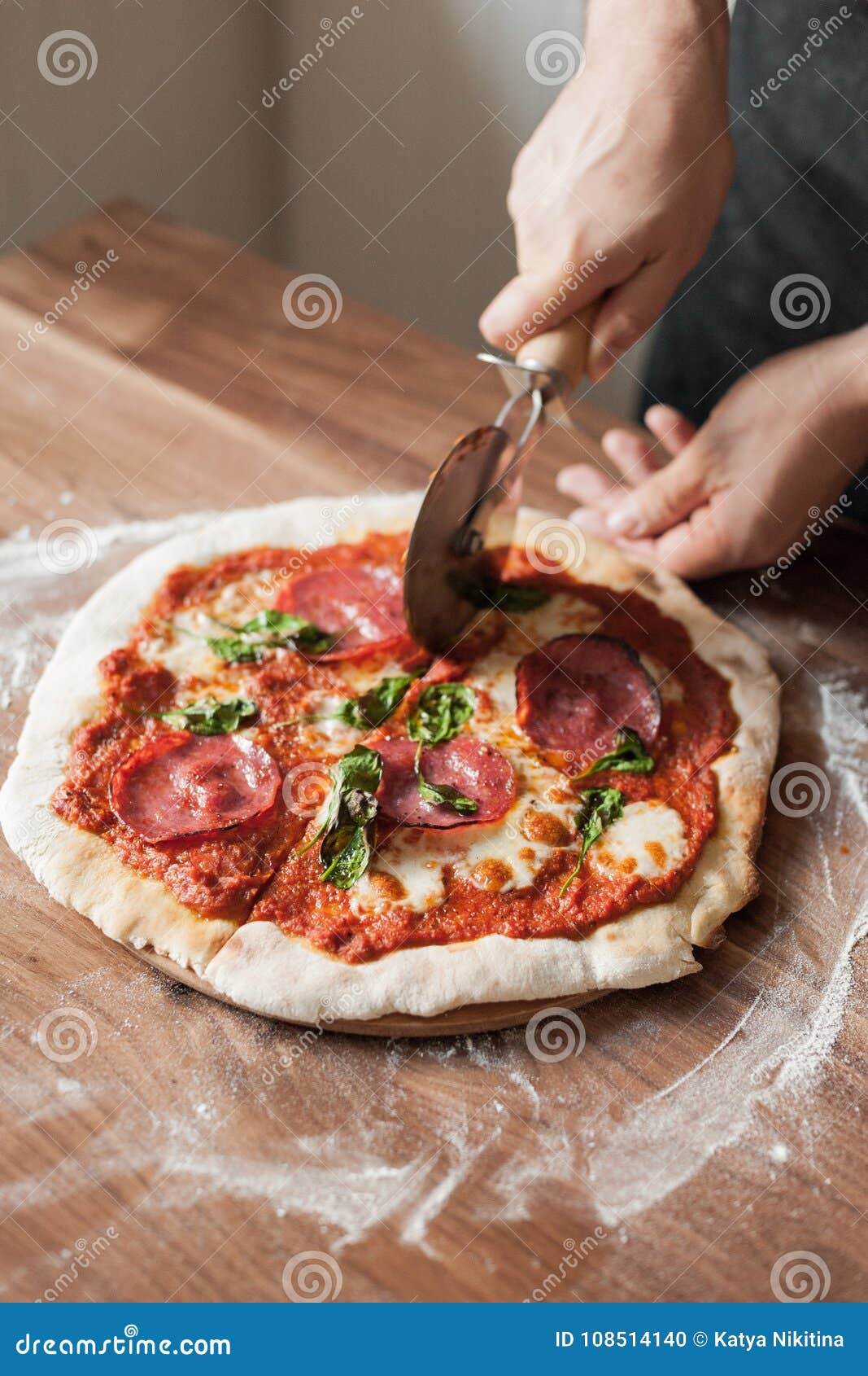 Hands Cooks Cut Pizza with a Special Pizza Knife on a Wooden Table with ...