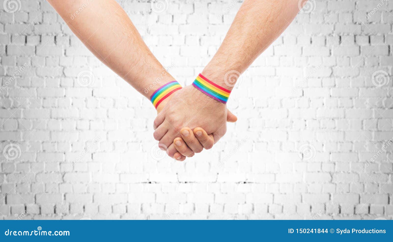 hands of couple with gay pride rainbow wristbands