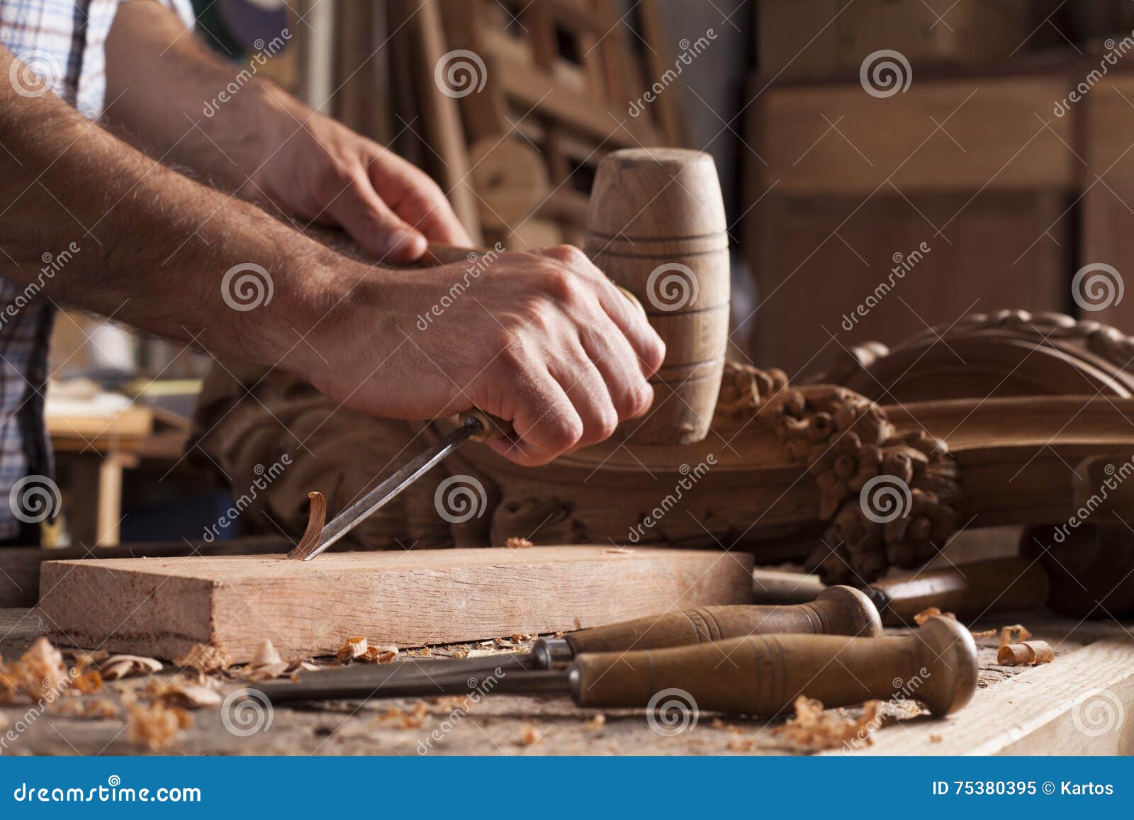 hands of craftsman carve with a gouge