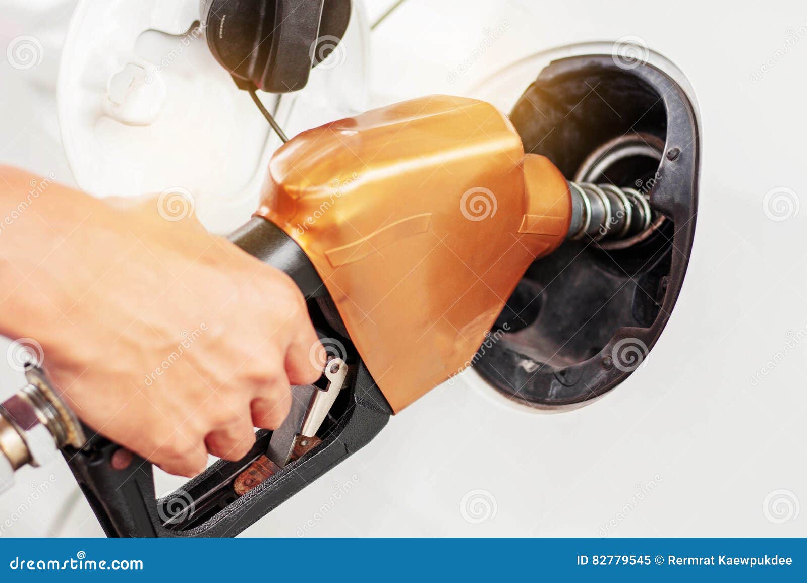 Hands dispensing fuel for cars.