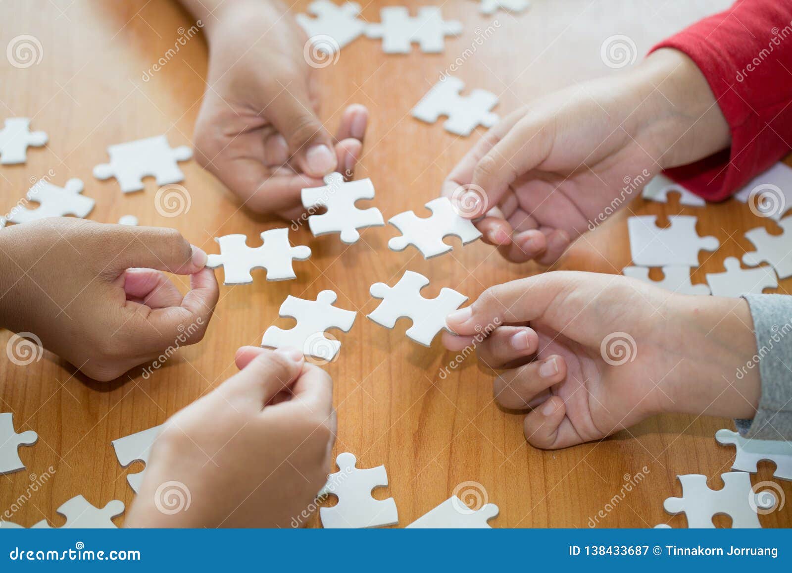 Hands of Diverse People Assembling Jigsaw Puzzle, Team Put Pieces