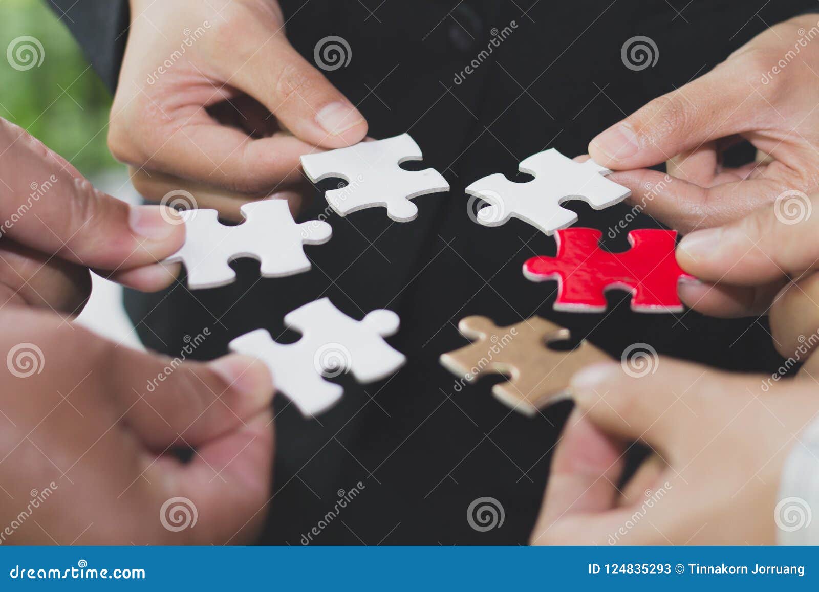hands of diverse people connecting puzzle together, team engagi