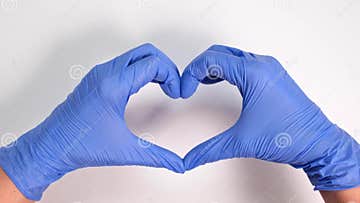 Hands of a Doctor or Nurse in Medical Gloves Depict a Heart on a White ...