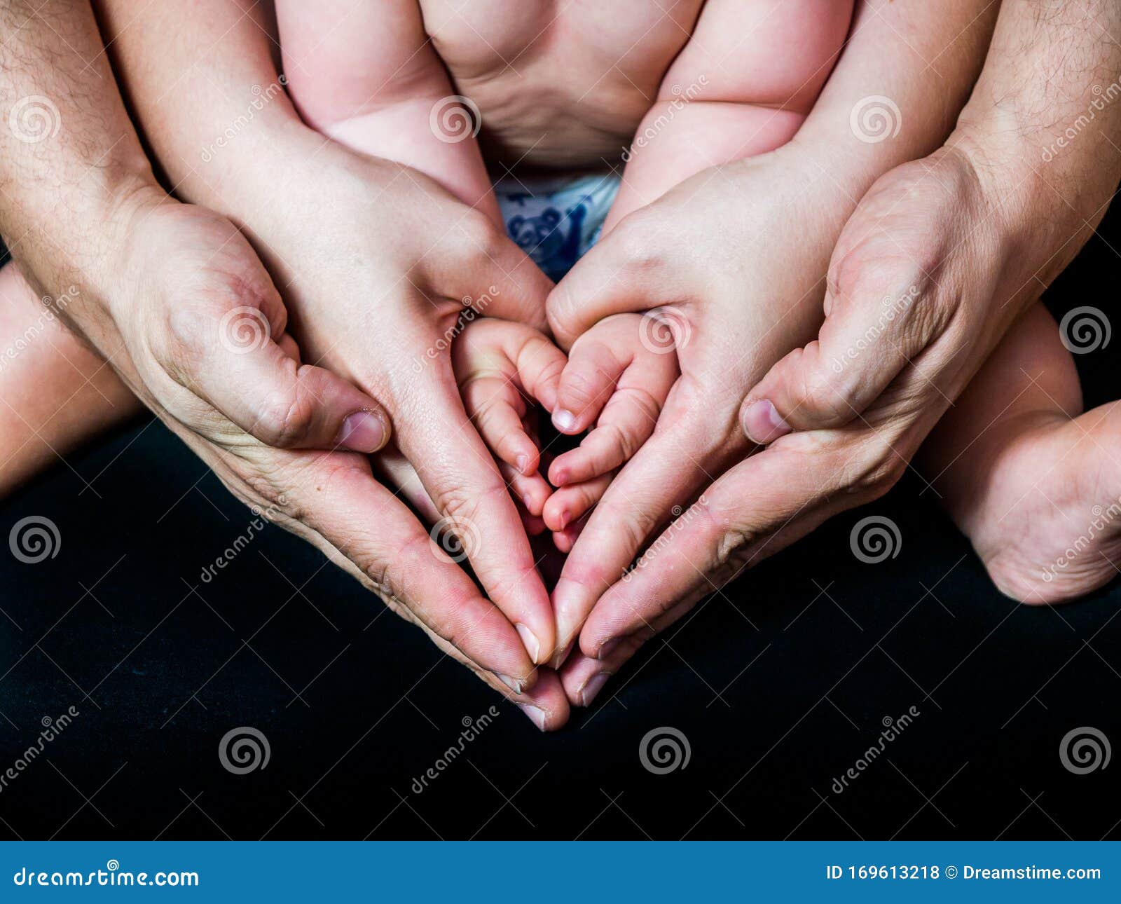 hands of a father a mother i a child in the form of a heart