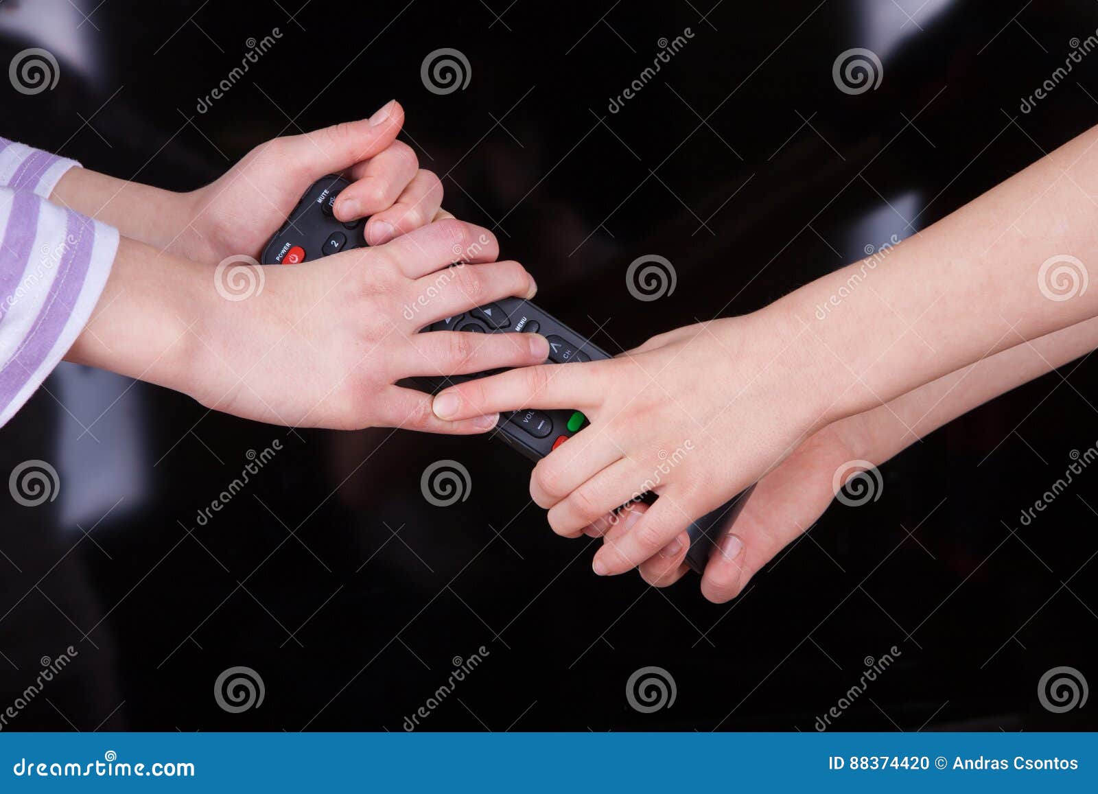 Hands Fighting for the Remote Control in Front of the TV Screen. Stock