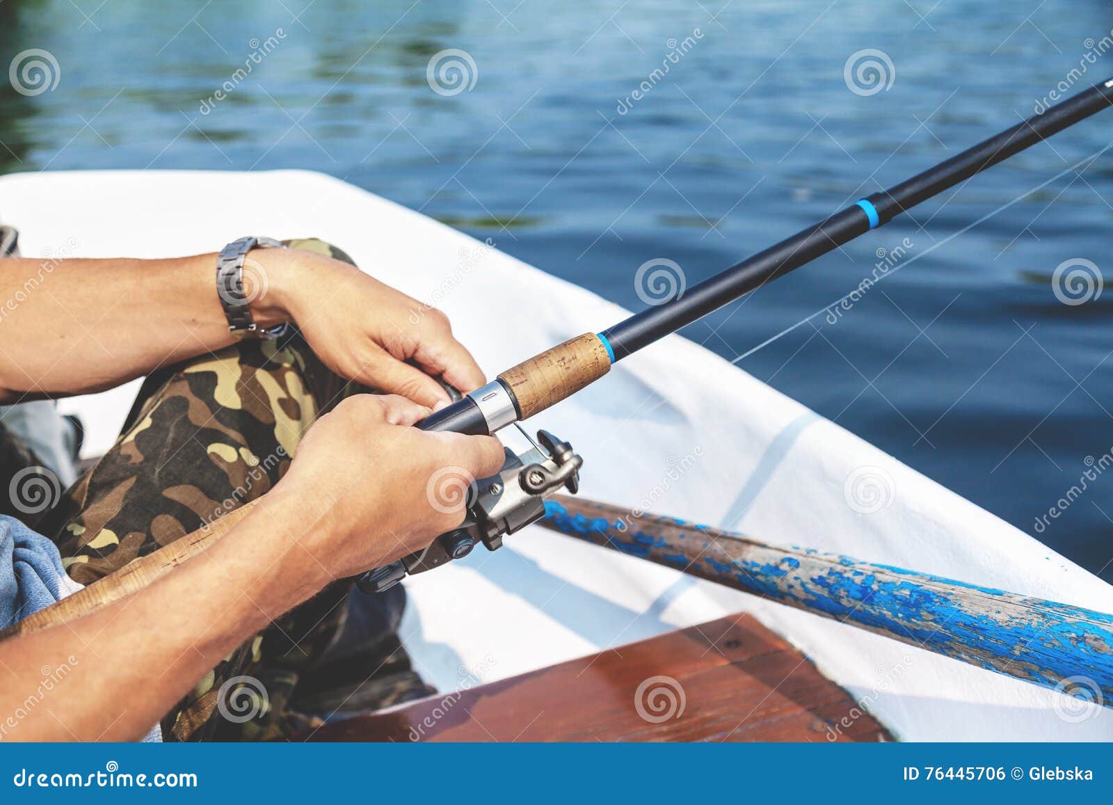 Hands Fisherman Holding Fishing Rod and Reel Handle is Rotated Stock Photo  - Image of active, device: 76445706