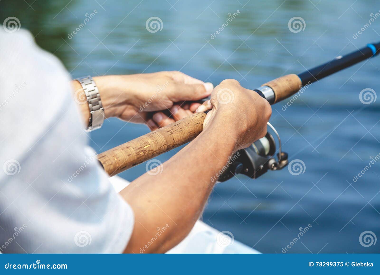 Hands Fisherman Holding Fishing Rod and Reel Handle is Rotated Stock Image  - Image of fish, fishing: 78299375